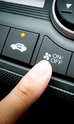 Finger pressing on Power button on off switch of a Car air conditioning and heating system
