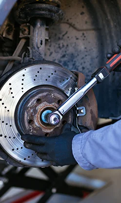 Mechanic fixing car brakes